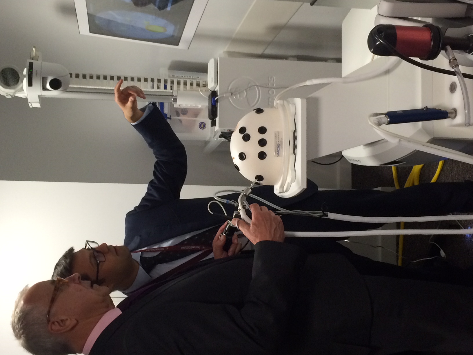 Faculty demonstrating a haptic VR simulator on a trolley